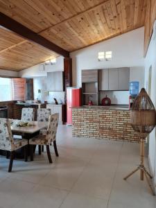 a kitchen and dining room with a table and chairs at Casa de ferias - Ferienhaus - House for holiday! in Uruau