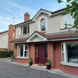 a brick house with a red door at Rock House in Carrickmacross