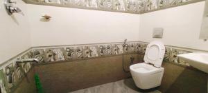 a bathroom with a toilet and a sink at The Butterfly cottage Vagamon in Vagamon