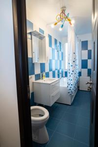 a blue and white bathroom with a toilet and a shower at Garsoniera LUX Drumul Taberei in Bucharest