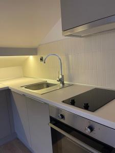 a kitchen with a sink and a counter top at Agora LX Studios & Suites in Thessaloniki +83 photos