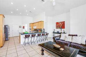 a living room with a couch and a kitchen at Tranquil Times in Palm Desert