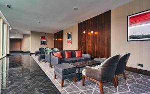 a waiting room with couches and a table and chairs at Crowne Plaza Marlow, an IHG Hotel in Marlow