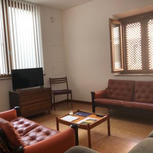 a living room with couches and a flat screen tv at Sossego Salgado in Tavira