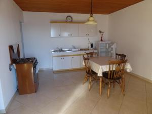 a kitchen and dining room with a table and chairs at Marijanka in Sveti Juraj