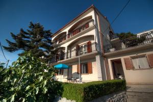 a large building with a tree in front of it at Marijanka in Sveti Juraj