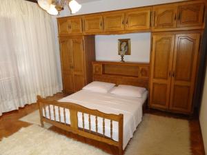 a bedroom with a bed with a wooden cabinet at Marijanka in Sveti Juraj