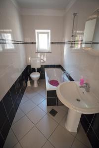 a bathroom with a tub and a toilet and a sink at Marijanka in Sveti Juraj