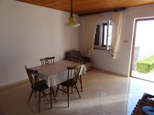 a dining room with a table and chairs at Marijanka in Sveti Juraj +25 photos
