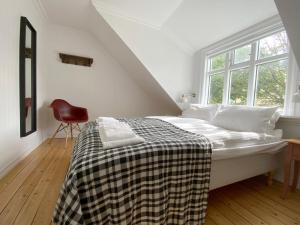 ein weißes Schlafzimmer mit einem Bett und einem Fenster in der Unterkunft Moon Apartments in Reykjavík
