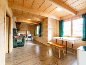 a wooden room with a table and a bench at Chochołowsko-Witowski Wypoczynek in Witów
