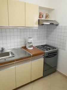 a small kitchen with a stove and a sink at Kaka in Sveti Juraj +26 photos