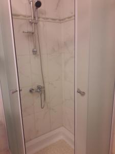 a shower with a glass door in a bathroom at Kaka in Sveti Juraj