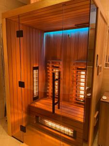 a sauna with a glass door in a room at Apartament Rynek - Zielona Kamienica in Duszniki Zdrój