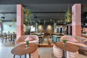 a lobby with tables and chairs and a restaurant at Hotel Sonne in Füssen