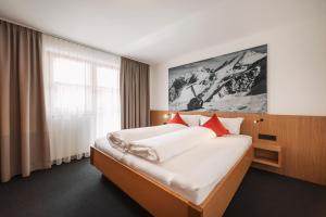Postel nebo postele na pokoji v ubytování Apart Garni St Martin - Silvretta Card Premium Betrieb