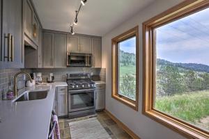 a kitchen with a sink and a large window at Modern Evergreen Duplex Directly Off I-70! in Idaho Springs