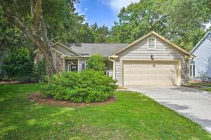 a house with a garage and a tree at Modern Retreat - 4 Miles to Isle of Palms Beach! in Charleston