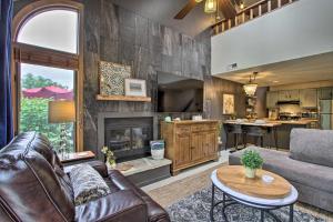 a living room with a couch and a fireplace at Lovely Townhome with Loft, 4 Mi to Lake Galena! in Galena