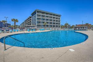 a large swimming pool in front of a building at Mod Myrtle Beach Resort Condo with Beach Access in Myrtle Beach