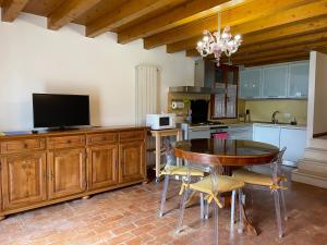 a kitchen with a table and a tv and a kitchen with a tableablish at Cà di Pizzo di Burano in Burano