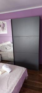 a bedroom with a mirror next to a bed at Apartmani Katarina in Zadar