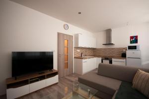 un soggiorno con divano e grande TV di MAYTEX - ubytovanie v 46m2 apartmáne s balkónom a Liptovský Mikuláš