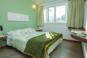 Een bed of bedden in een kamer bij Pousada Verbicaro