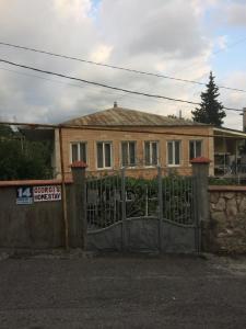 a house with a gate in front of it at Giorgi's Homestay in Kutaisi