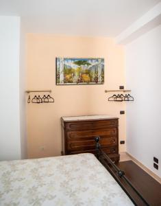 1 dormitorio con 1 cama y una pintura en la pared en La Maison de Miki en Lecco