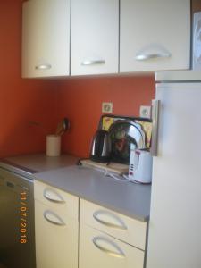 eine Küche mit weißen Schränken und einem weißen Kühlschrank in der Unterkunft Maison de campagne MONTCUQ en Quercy Blanc in Montcuq