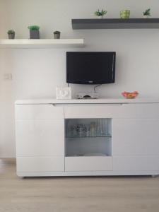 a white entertainment center with a television on top of it at Pretty View Borinquen Playa de las Americas in Playa Fañabe
