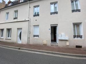 um edifício branco ao lado de uma rua em Vichy Centre ville - Gare - Parc des sources em Vichy