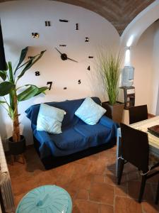 a living room with a couch and a clock on the wall at CA MATILDE in Ivrea