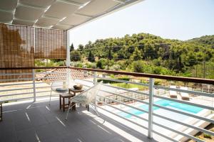 a balcony with a view of the mountains at Villa Kyani in Skopelos Town