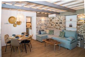 a living room with a blue couch and a table at Villa Kyani in Skopelos Town