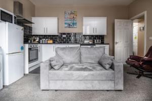 a living room with a couch in a kitchen at 2 bedroom Llandudno holiday apartment in Llandudno