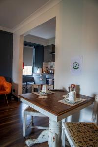 a kitchen with a wooden table in a room at Caledonian Canal Studio in Inverness