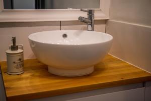 a white sink on a wooden counter in a bathroom at Caledonian Canal Studio in Inverness