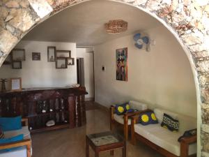 an archway in a living room with a couch and tables at Kendwa Beach BnB in Kendwa