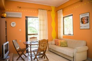 a living room with a couch and a table at Dionysia's Apartments in Tsilivi