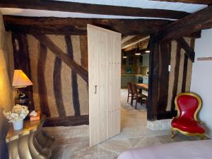 a room with a wooden door and a dining room at 16 CHEMIN DE BOISBELET in Coutras