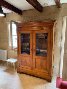 a wooden cabinet in the corner of a room at 16 CHEMIN DE BOISBELET in Coutras +12 photos