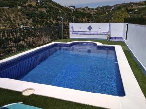 a swimming pool in the middle of a yard at La Revuelta in Yunquera