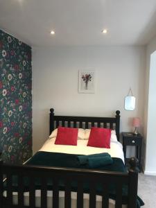
a bedroom with a bed and a lamp at 1 Phoenix Cottages, 403 High Street, Cheltenham in Cheltenham
