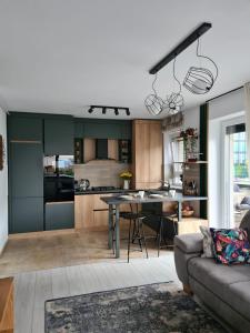 uma cozinha e sala de estar com uma mesa e um sofá em Tonic Studio Coresi em Brasov