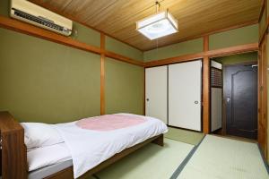 Voodi või voodid majutusasutuse Tabist HotelNakajima Fuji toas