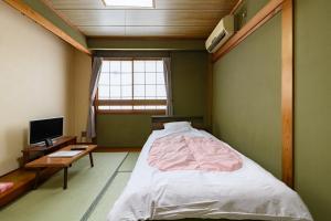 Voodi või voodid majutusasutuse Tabist HotelNakajima Fuji toas