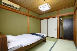 Voodi või voodid majutusasutuse Tabist HotelNakajima Fuji toas