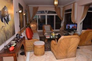 a living room with wicker furniture and a television at قصر 2 in Sharm El Sheikh